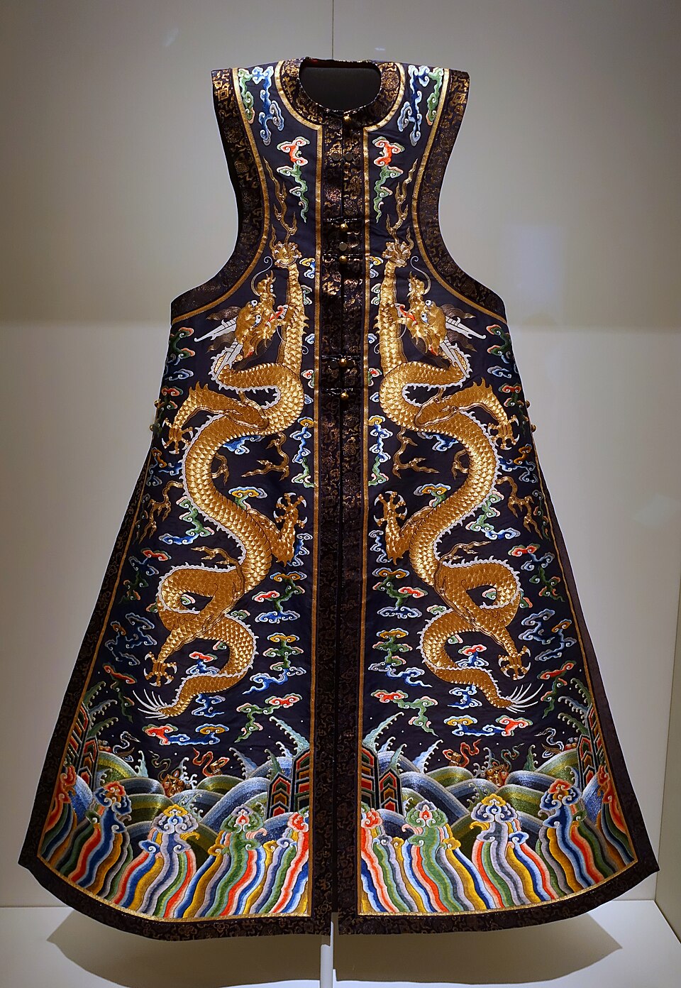 Traditional Chinese silk embroidery — imperial dragon robe with gold thread dragons, coloured clouds, and wave borders on dark blue silk fabric